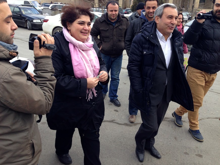 Khadija Ismayilova and her lawyer, Elton Guliyev, walkng outside en route to the offices of the Azerbaijani Prosecutor General to respond to a summons to appear. Baku, Azerbaijan.