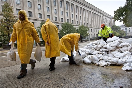 Workers haul sandbags to shore up vulnerable spots near federal buildings in Washington, DC
