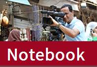 The word Notebook over a photo of a man using a video camera