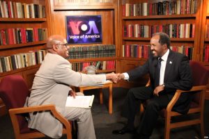 VOA’s Somali Chief Abdirahman Yabarow (left) greets President Hassan Sheikh Mohamud