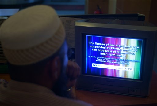 A Pakistani viewer looks at a television screen