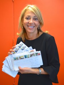 The Director of the Office of Cuba Broadcasting, Maria “Malule” González, with some of the many letters the Martís have received.