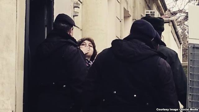 Khadija Ismayilova tries to greet supporters and journalists outside the Baku courtroom on January 27, when she had her pretrial detention extended.